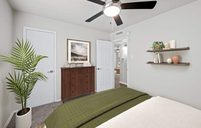 a bedroom with a bed and a ceiling fan  at Sunset Heights, San Antonio