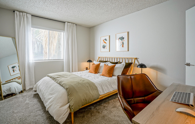 Furnished platinum bedroom interior with fresh carpeting inside Treehouse in Albuquerque, New Mexico