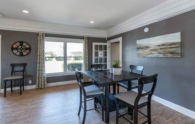 a dining room with a table and chairs