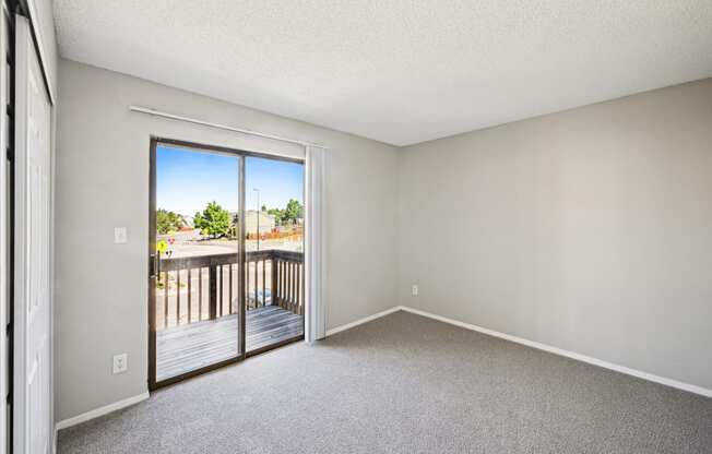 an empty bedroom with white walls and carpet