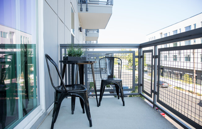Balcony off of the unit with modern outdoor furniture
