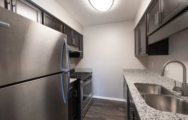 Kitchen with Stainless Steel Appliances in the Two Bedroom One Bath Apartment at Woodbridge Apartments Bloomington