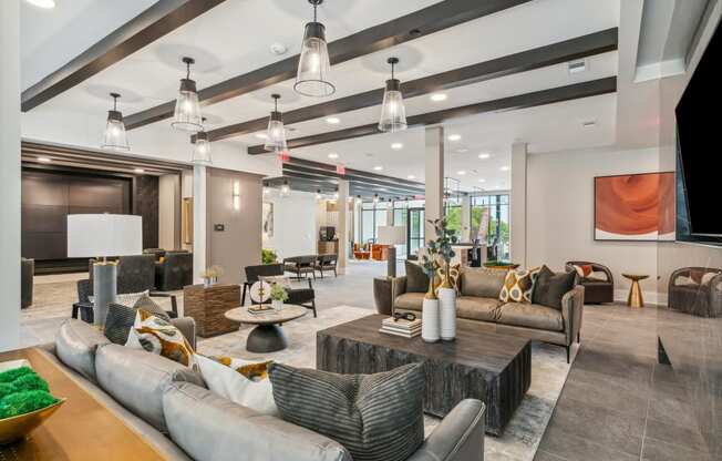 the lobby of a clubhouse with couches and tables