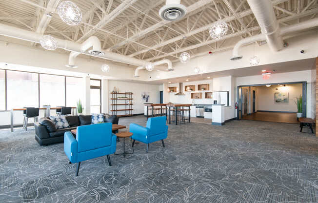 A spacious room with a patterned carpet and a variety of seating options.