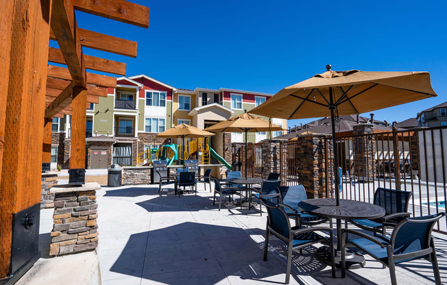 an outdoor patio with tables and chairs and umbrellas