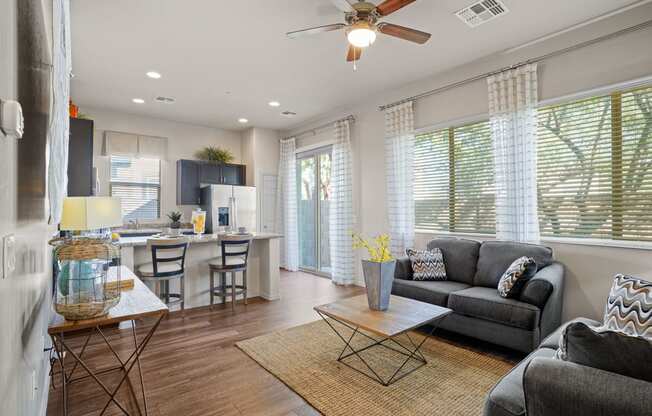 an open living room and kitchen with a ceiling fan