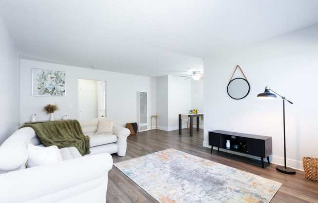 a living room with a white couch and a rug