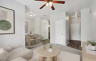 an open living room and dining room with a ceiling fan