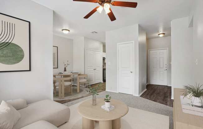 an open living room and dining room with a ceiling fan