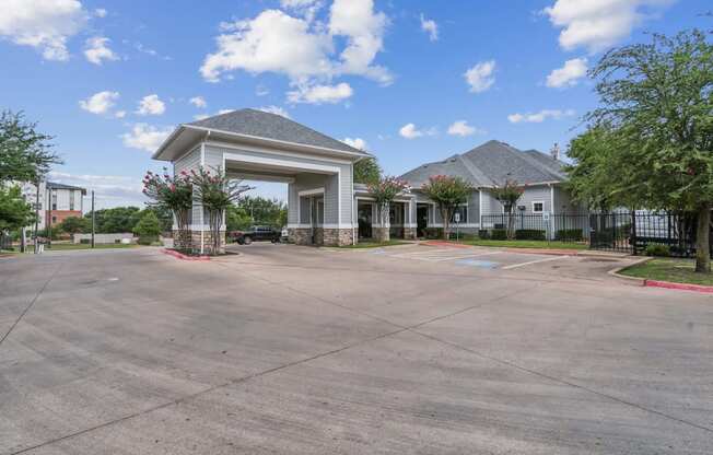 an empty parking lot with a building in the background at St. Augustine Estate, Texas 75227