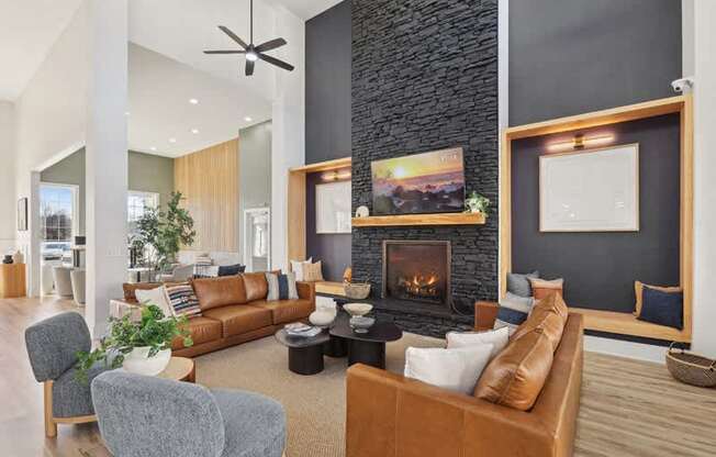A modern living room with a fireplace and a ceiling fan.