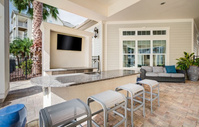 a patio with a bar and a couch