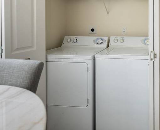 Full-size washer and dryer behind closet doors