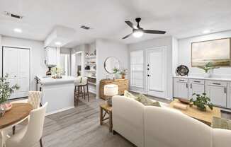 a living room and kitchen with white walls and a wooden floor at Carmel at Deerfield, San Antonio, 78248
