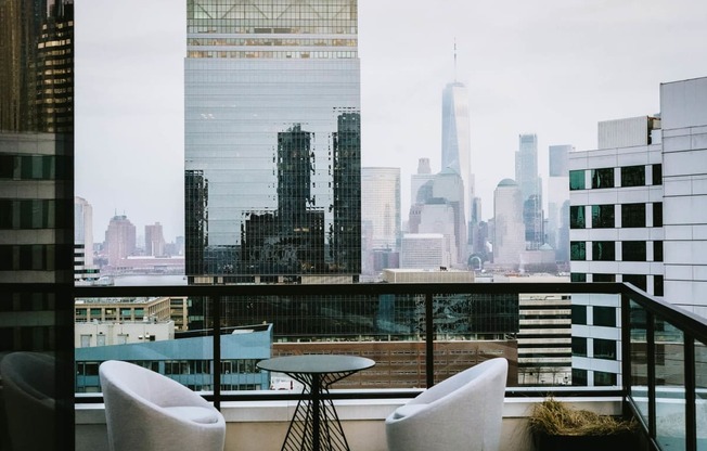 a view of the city skyline from a restaurant with a glass window at The Lively, Jersey City, NJ 07302