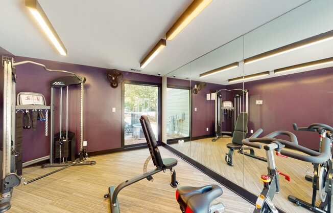a home gym with exercise equipment and mirrors