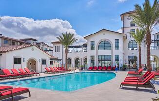 a house with a pool in front of a building