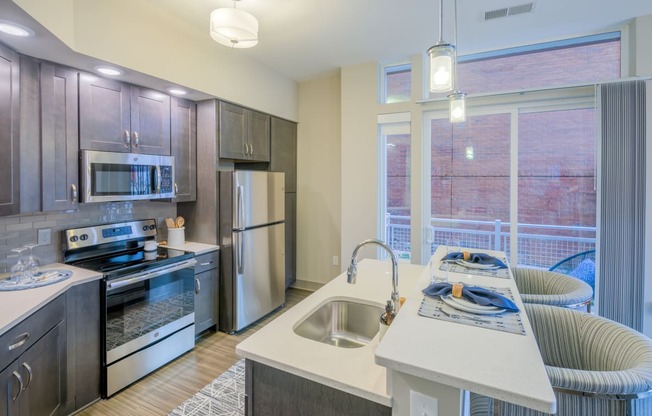 a kitchen with stainless steel appliances and a large window