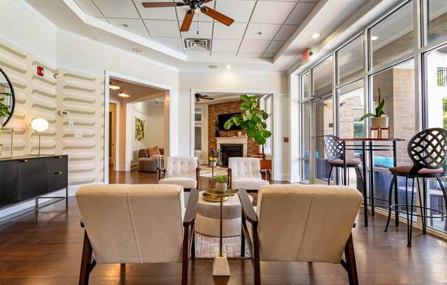 a living room with a table and chairs and a fireplace