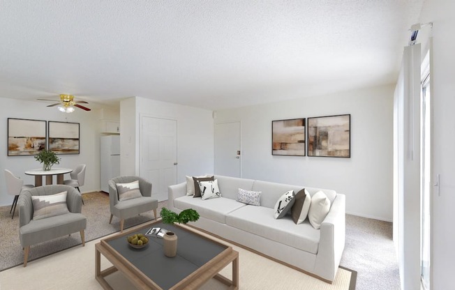 A living room with a white couch, a coffee table, and a ceiling fan.