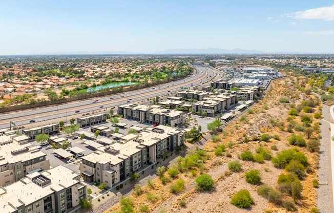 A view of a residential area with houses and a highway.