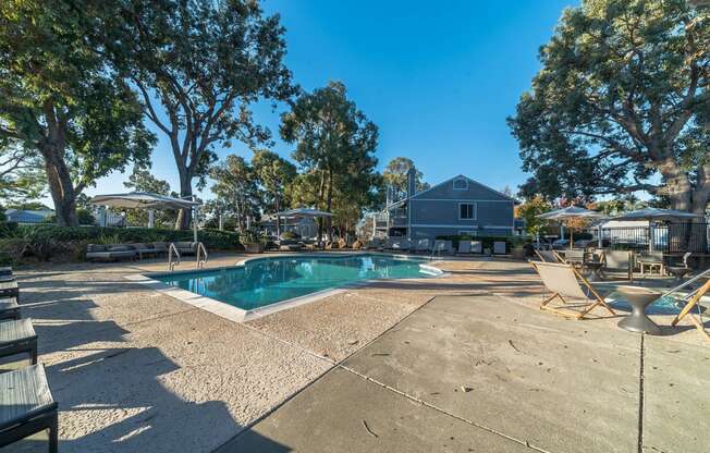 a pool with chairs and trees and a house in the background at Bay Village, Vallejo, CA, 94590