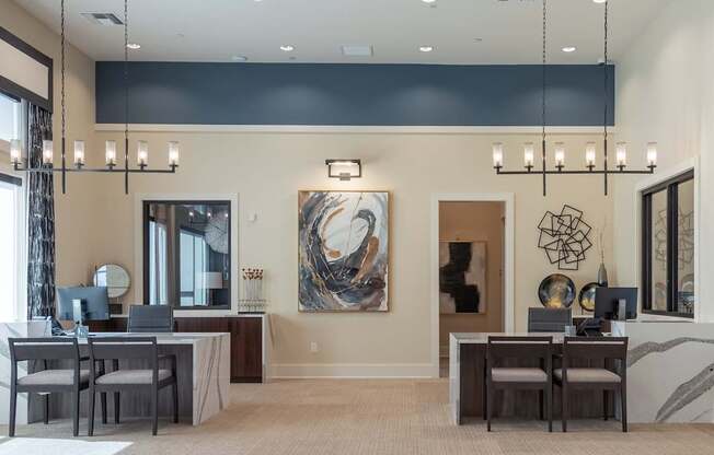 A modern home office with a large painting on the wall and a desk with a laptop and a chair.