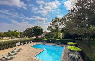Pool with sundeck at Woodland Villa Apartments in Westland, MI.