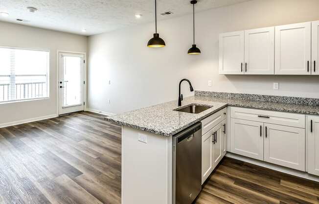 Studio, one and two bedroom apartment homes featuring stainless steel appliances, luxury vinyl floor, granite countertops, large closets and full-size washer and dryer at The Parker in Papillion, NE