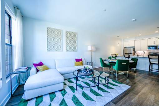 a living room with a white couch and a glass coffee table