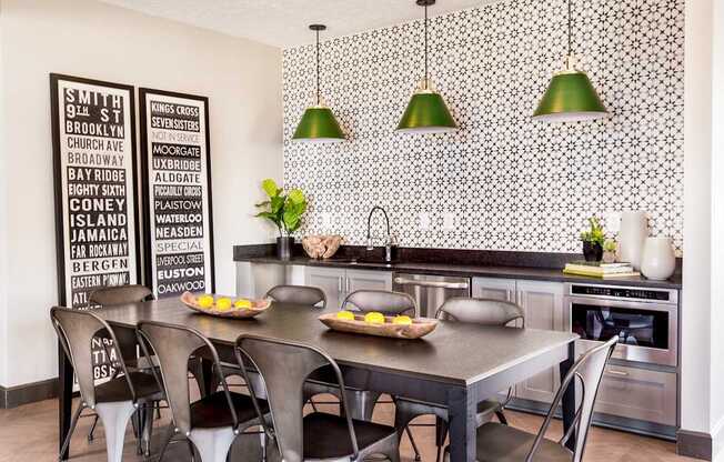 a dining room with a table and chairs and a kitchen with green lights