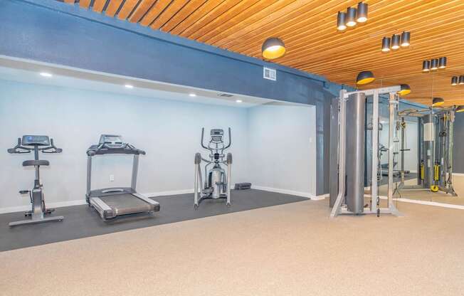 a room filled with stainless steel pipes and urinals