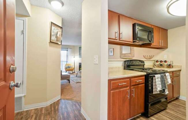 A kitchen with wooden cabinets and a black stove top oven.