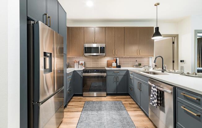 Gourmet kitchens feature quartz countertops, custom cabinetry, stainless steel appliances, and generous storage for a streamlined cooking experience.