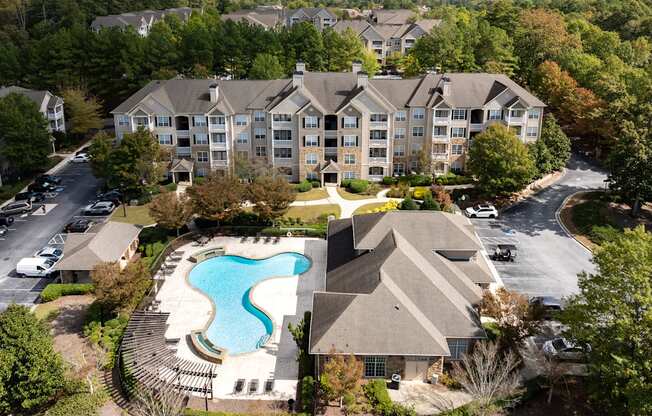 An aerial view of a resort with a swimming pool.