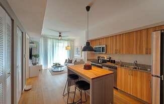 a kitchen with wooden cabinets and a island with three stools