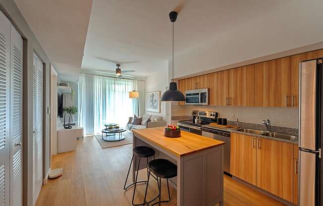 a kitchen with wooden cabinets and a island with three stools