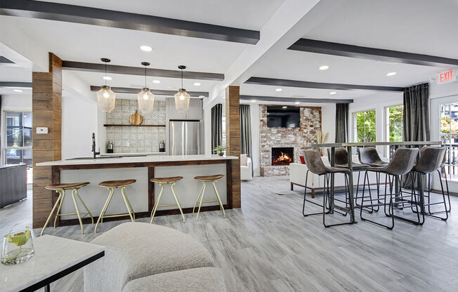 a kitchen with a bar and a living room with a fireplace