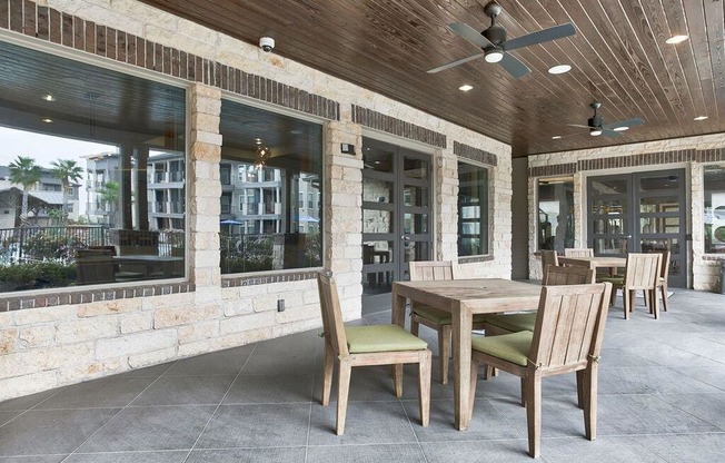 a patio with a wooden table and chairs at Legacy Flats, San Antonio Texas