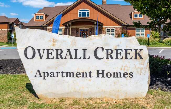 an overhead creek apartment homes sign in front of a house