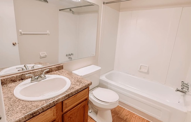 a bathroom with a sink toilet and a bath tub