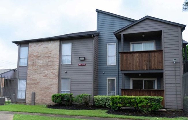 an apartment building and brick and a wooden balcony