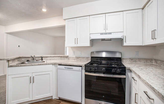 A kitchen with a stove and cabinets.