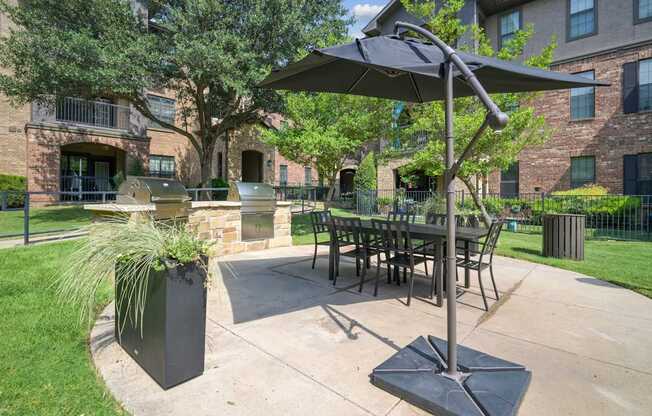 A patio with a table and chairs under a canopy.