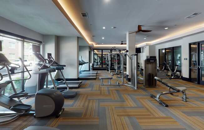 a large fitness room with treadmills and other exercise equipment