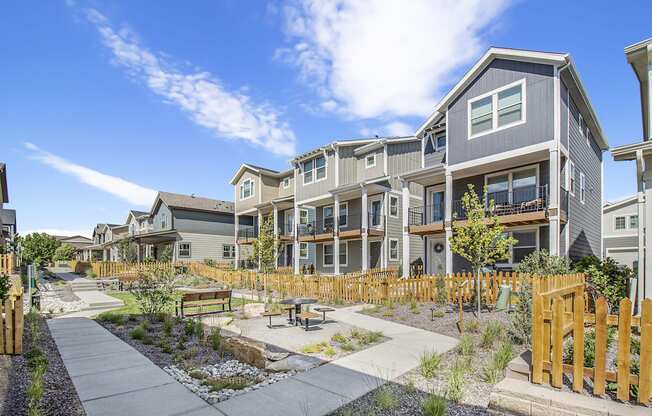 an outdoor area with a picnic table in front of an apartment building