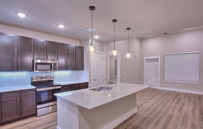 a kitchen with a sink and a counter top at Hunters Creek Apartments, Denton, TX