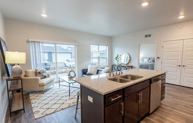 an open living room and kitchen with a view of a living room with a couch at Technology Park Apartments, Rochester