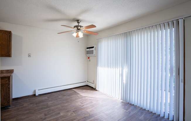 a dining room with curtains and a ceiling fan. Eagan, MN Glen Pond Apartments