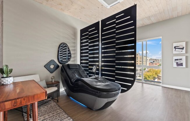 A modern room with a futuristic chair in the center.